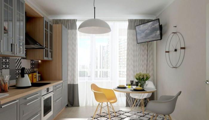Cucina design con mobili grigi e una sedia gialla