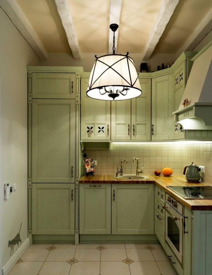 Illuminazione e travi finte in una cucina in stile provenzale